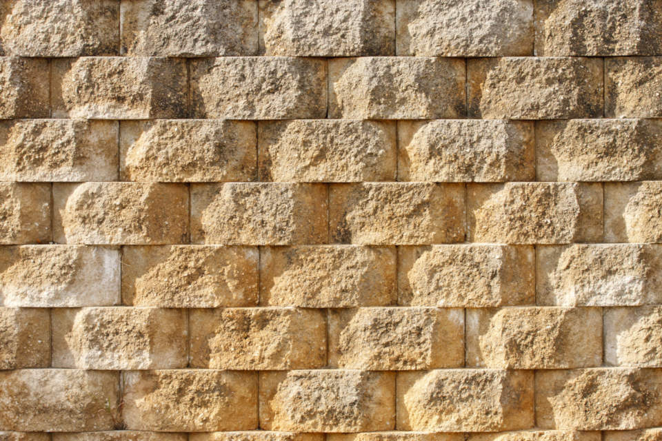 Concrete block is very durable and designed specifically for retaining walls